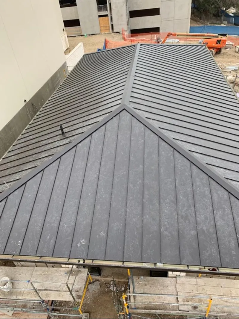 Commercial metal roof construction with crane equipment in Mitchellville